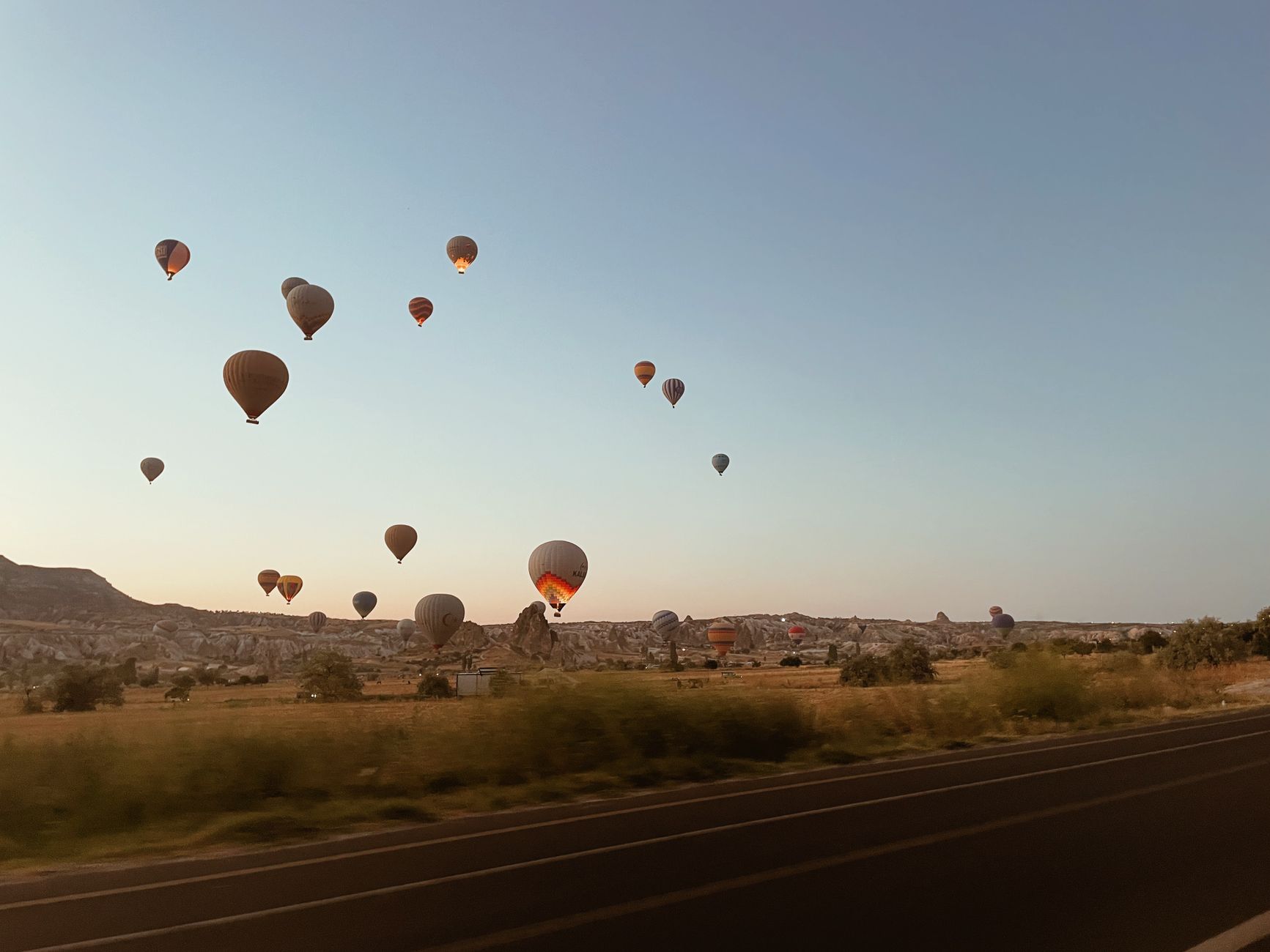 Montgolfières au lever du soleil au-dessus des paysages de Cappadoce