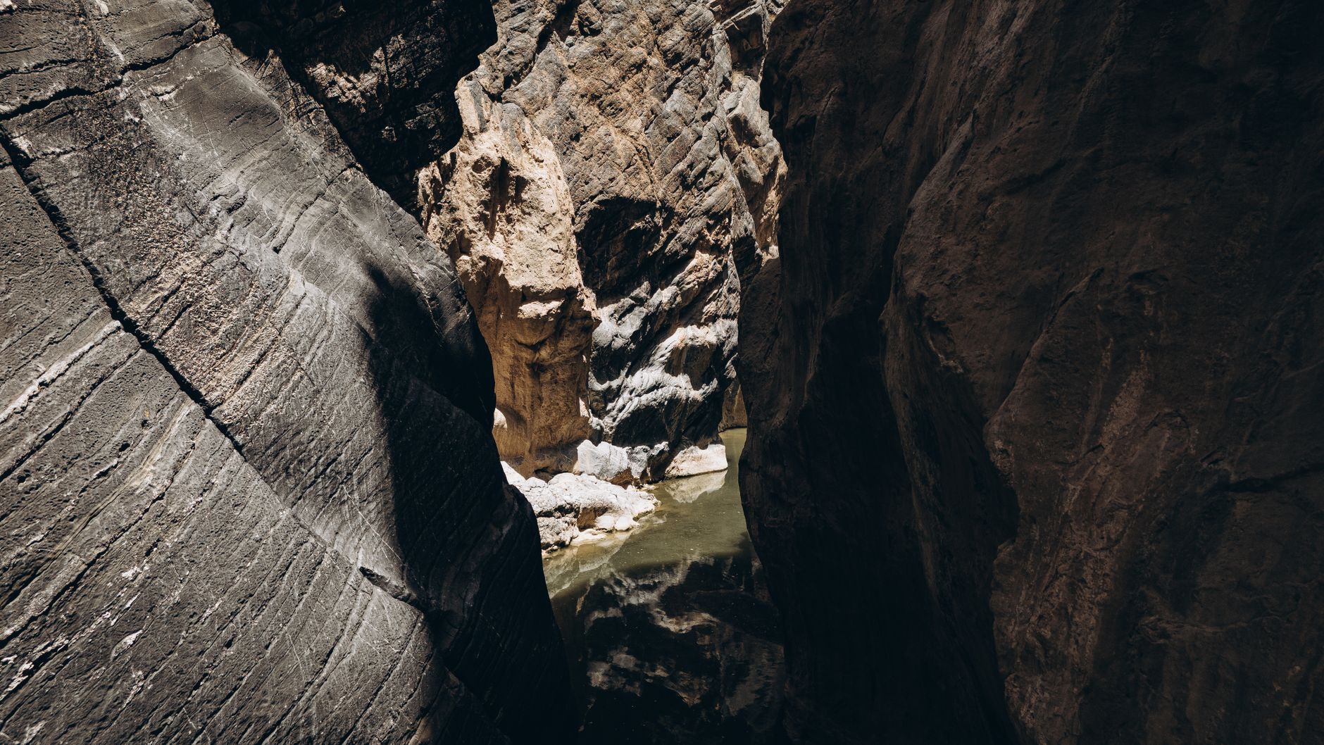 Vue aérienne d'un canyon profond parcouru par une eau turquoise, Oman